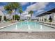Beautiful pool area includes water features, resort-style seating, and lush landscaping at 8872 Bismarck Palm Dr, Winter Garden, FL 34787