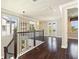 Bright second-floor landing with hardwood floors, large windows, and views of the neighborhood at 8872 Bismarck Palm Dr, Winter Garden, FL 34787