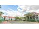 Community tennis court surrounded by lush landscaping and scenic buildings at 11562 Westwood Blvd # 934, Orlando, FL 32821