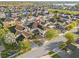 Expansive aerial view of a neighborhood featuring well-maintained homes, lush landscaping, and a beautiful lakeside backdrop at 14645 Scott Key Dr, Winter Garden, FL 34787