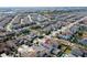 An overhead shot shows a neighborhood with solar panels, a screened-in pool, and well-kept landscaping at 14645 Scott Key Dr, Winter Garden, FL 34787