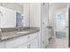 Bathroom featuring granite countertop, vanity, and a view into the bath and shower at 14645 Scott Key Dr, Winter Garden, FL 34787