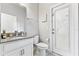 Cozy bathroom with white cabinets, granite counters, and door to the exterior at 14645 Scott Key Dr, Winter Garden, FL 34787