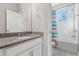 Bathroom featuring granite countertop, vanity, and a tub with tiled shower at 14645 Scott Key Dr, Winter Garden, FL 34787