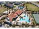 Aerial view of resort-style community pool, clubhouse, tennis courts, and lush landscaping at 14645 Scott Key Dr, Winter Garden, FL 34787