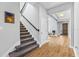 Welcoming entryway features wood flooring, a staircase with metal railing, and a view into the home at 14645 Scott Key Dr, Winter Garden, FL 34787