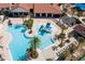 Aerial view of a community pool featuring a splash pad, multiple lounge areas, and lush tropical landscaping at 14645 Scott Key Dr, Winter Garden, FL 34787