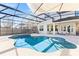 Sparkling pool with a slide surrounded by a screened enclosure and a patio area for relaxation at 14645 Scott Key Dr, Winter Garden, FL 34787