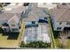 Aerial shot of a private backyard pool, screened-in for comfort, surrounded by a manicured lawn and white fencing at 14645 Scott Key Dr, Winter Garden, FL 34787