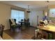 Cozy dining area featuring wood floors, a decorative light fixture, and lots of natural light at 1486 Randolph St, Deltona, FL 32725