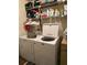 Functional laundry room with washer, dryer, and storage shelves at 1486 Randolph St, Deltona, FL 32725