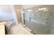 Bathroom showcasing a glass-enclosed shower, tub, and modern fixtures at 16161 Barkly Ridge Ct, Winter Garden, FL 34787