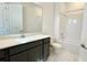 Bright bathroom features a modern vanity with white countertop and a shower-tub combo with white tile surround at 16161 Barkly Ridge Ct, Winter Garden, FL 34787