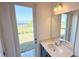 Bathroom features a modern vanity and a door that provides access to the yard and lake view at 16161 Barkly Ridge Ct, Winter Garden, FL 34787