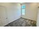 Neutral bedroom features carpet and three windows overlooking the lake at 16161 Barkly Ridge Ct, Winter Garden, FL 34787