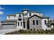 Stunning two-story home boasting stone accents, a turret, and a two-car garage, set against a clear blue sky at 16161 Barkly Ridge Ct, Winter Garden, FL 34787