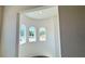 Bright foyer featuring arch windows and a view of the neighborhood at 16161 Barkly Ridge Ct, Winter Garden, FL 34787