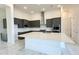 A view of the modern kitchen with an island, stainless steel appliances, and white countertops at 16161 Barkly Ridge Ct, Winter Garden, FL 34787