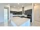 A view of the spacious kitchen with an island, stainless steel appliances, and modern light fixtures at 16161 Barkly Ridge Ct, Winter Garden, FL 34787