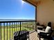 Balcony featuring wicker chairs, a table, and great views of the lake at 16300 County Road 455 # 513, Montverde, FL 34756