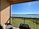 Balcony with seating and table offering scenic views of the lake and lush landscape at 16300 County Road 455 # 513, Montverde, FL 34756