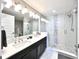 En suite bathroom featuring a glass shower, dual sinks and modern fixtures at 16300 County Road 455 # 513, Montverde, FL 34756