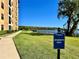 The Siena at Bella Collina building exterior next to a lush green lawn with lake views at 16300 County Road 455 # 513, Montverde, FL 34756