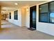 Hallway view to an apartment door, windows, and an exterior light fixture at 16300 County Road 455 # 513, Montverde, FL 34756