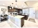 Modern kitchen with white countertops, pendant lighting, stainless appliances, and dark wood cabinetry at 16300 County Road 455 # 513, Montverde, FL 34756