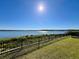 Beautiful community lake view from a well-manicured lawn behind a black metal fence at 16300 County Road 455 # 513, Montverde, FL 34756