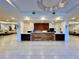 An elegant lobby area with a reception desk, modern lighting, and comfortable seating at 16300 County Road 455 # 513, Montverde, FL 34756