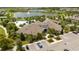 Aerial view of community clubhouse, resort-style pool, parking, and landscaping at 17101 Water Spring Blvd, Winter Garden, FL 34787