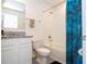 Well-lit bathroom features a shower-tub combo, granite counters, and tiled walls at 17101 Water Spring Blvd, Winter Garden, FL 34787