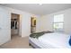 Bedroom featuring closet, bathroom, carpet and natural light from the window at 17101 Water Spring Blvd, Winter Garden, FL 34787