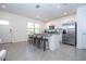 Bright kitchen with stainless steel appliances, a breakfast bar, and an abundance of natural light from the window at 17101 Water Spring Blvd, Winter Garden, FL 34787