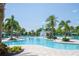 Resort-style community pool featuring palm trees and a decorative fountain, ideal for leisurely swims at 17101 Water Spring Blvd, Winter Garden, FL 34787