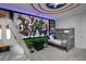 Marvel-themed bedroom with bunkbeds, gaming area and Captain America emblem on ceiling for a fun, immersive experience at 1720 Sawyer Palm Pl, Kissimmee, FL 34747