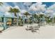 Outdoor cabana area with comfortable seating, tables, and shade, creating a relaxing retreat near the pool at 1720 Sawyer Palm Pl, Kissimmee, FL 34747