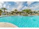 Large community pool with water features, surrounded by palm trees and seating areas at 1720 Sawyer Palm Pl, Kissimmee, FL 34747