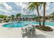 Resort-style pool area with comfortable seating, lush palm trees, and a serene atmosphere at 1720 Sawyer Palm Pl, Kissimmee, FL 34747