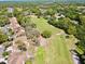 Aerial view of the golf course in a residential community with mature tree coverage at 1886 Saint Andrews Pl # 1886, Longwood, FL 32779