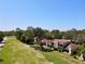 A beautiful aerial view of townhomes backing onto a golf course, surrounded by lush greenery and mature trees at 1886 Saint Andrews Pl # 1886, Longwood, FL 32779