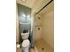Cozy bathroom featuring a shower with a curtain, a toilet, and wall-mounted lighting at 1886 Saint Andrews Pl # 1886, Longwood, FL 32779