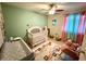 Lovely Bedroom with a crib, rocker, and colorful decor at 1886 Saint Andrews Pl # 1886, Longwood, FL 32779