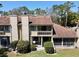 Rear exterior of the townhome features a balcony, screened-in patio, and manicured bushes at 1886 Saint Andrews Pl # 1886, Longwood, FL 32779