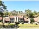 Aerial view of the back of the townhome featuring a second story balcony and a spacious fenced yard at 1886 Saint Andrews Pl # 1886, Longwood, FL 32779