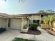 Charming townhome featuring an attached garage and inviting front entry with manicured landscaping at 1886 Saint Andrews Pl # 1886, Longwood, FL 32779