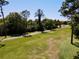 Lush green landscape with trees and a winding pathway in the distance at 1886 Saint Andrews Pl # 1886, Longwood, FL 32779