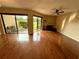 Spacious living room with hardwood floors, fan, fireplace, and sliding glass doors that lead to a patio at 1886 Saint Andrews Pl # 1886, Longwood, FL 32779