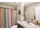 Functional bathroom with a large mirror and an orange and blue shower curtain at 2087 Crystal Bell St, Orlando, FL 32824